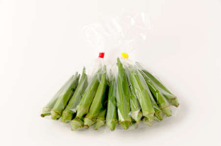 fresh Okra in plastic bag on white backgroundの写真素材