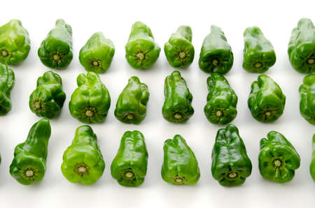 Deformed bell peppers on a white backgroundの写真素材