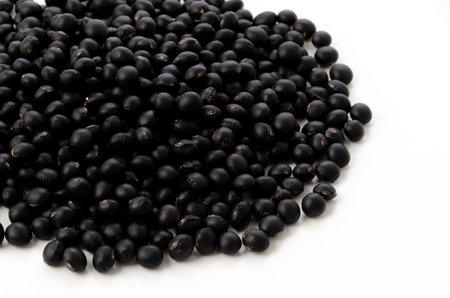 uncooked black beans isolated on white backgroundの写真素材