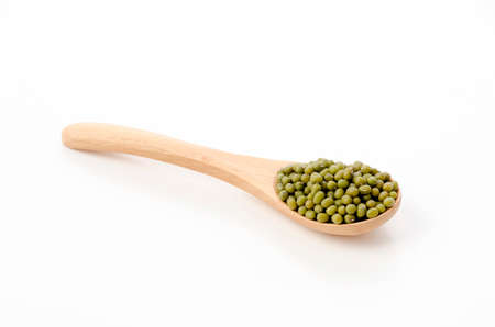 mung beans in wooden spoon over white backgroundの写真素材