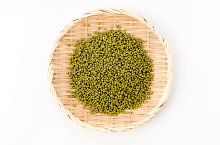 mung bean on bamboo sieve on white backgroundの写真素材