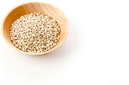 Job's tears( Adlay millet) in wooden bowl on white backgroundの写真素材