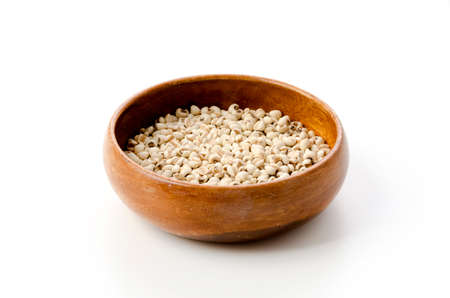 Job's tears( Adlay millet) in wooden bowl on white backgroundの写真素材