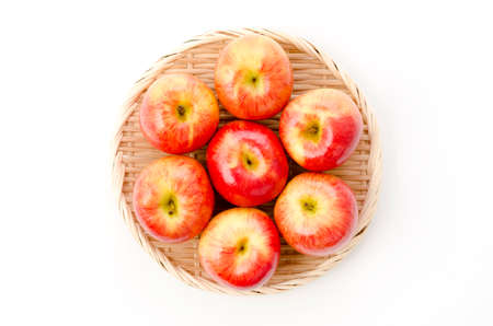 Jazz apples on a  bamboo sieve on white background