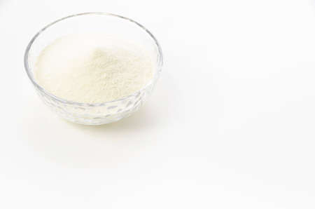 Skim milk powder in Glass bowl on white background