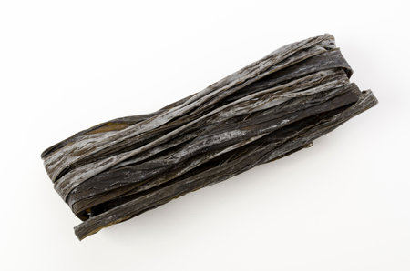 Dried kombu seaweed, Japanese dry kelp isolated on white backgroundの写真素材
