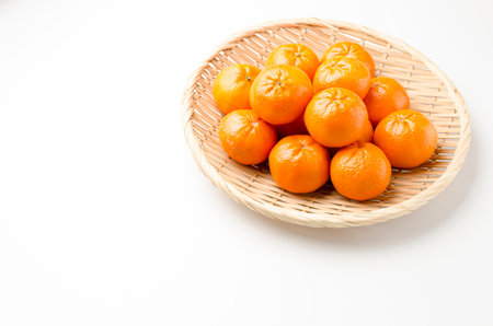 tangerine, Afourer Mandarin on Bamboo sieve on white backgroundの写真素材