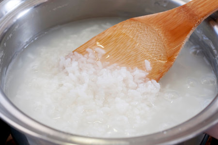 Cooking rice porridge in a pan, Okayu, Japanese rice porridgeの写真素材