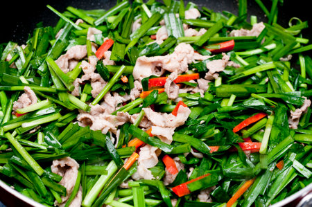 Stir-fried pork with garlic chives and carrotの写真素材