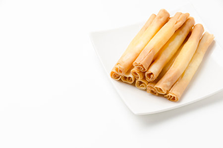 Cheese sticks on plate on white background