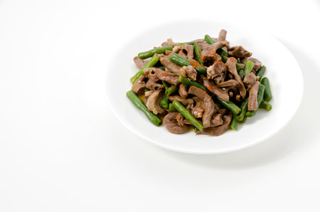 stir-fried Pork Heart with green beans on a white background.の写真素材