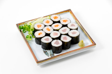 Delicious makizushi set with salmon thin roll and  tuna thin roll served on square plate with piquant wasabi paste and white radish sprouts.の写真素材