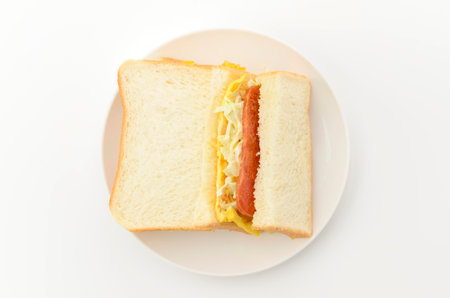 Pork luncheon meat, tamagoyaki (Japanese omelette) and coleslaw sandwiched between slices of breadの写真素材