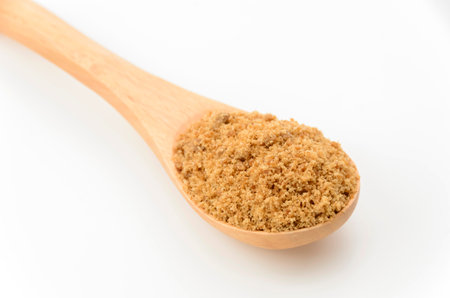 Powdered brown sugar on spoonの写真素材