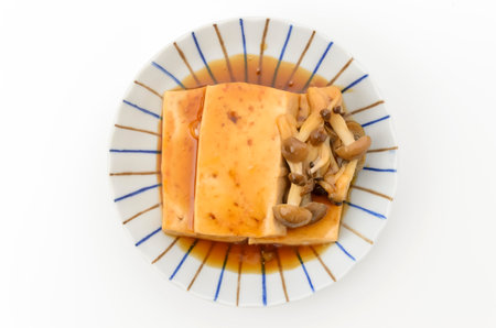 Tofu pudding with mushroom and honey sauce on white background.の写真素材
