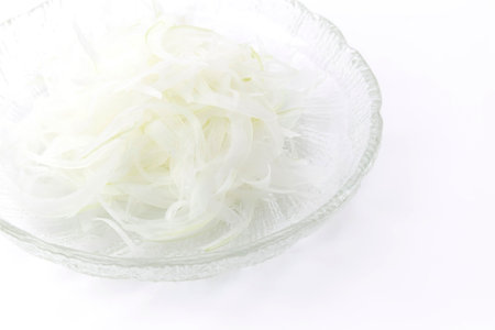 sliced onion in glass bowl on white background, food ingredient