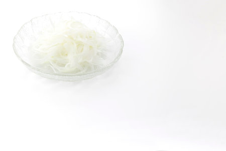 Sliced food in a glass bowl isolated on white background.の写真素材