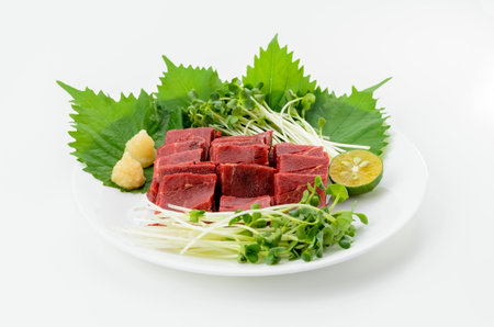 Japanese cuisine, raw beef sashimi with vegetable on white background