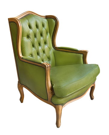 Elegant vintage wooden armchair with green leather upholstery and pillow isolated on white backgroundの写真素材
