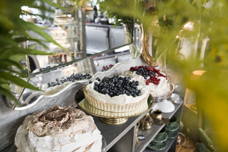 Three cakes on a vintage shelf on the background of a mirror.の写真素材