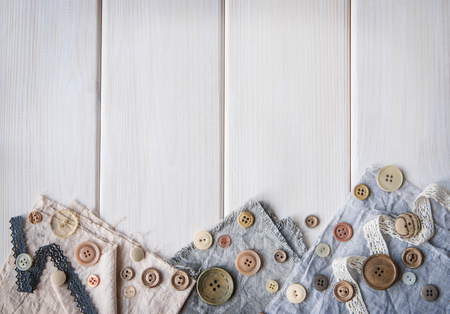 Vintage buttons, old cloth on a wooden table. Rustic style. Needlework. Ð¡opy space.の写真素材