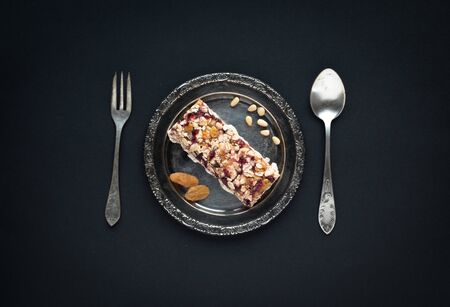 Plate with granola, fork and spoon on a blackの写真素材