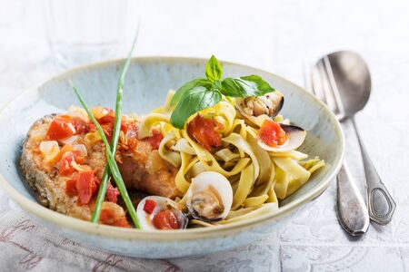 Tagliatelle with grilled salmon in a cream sauce with the addition of white wineの写真素材