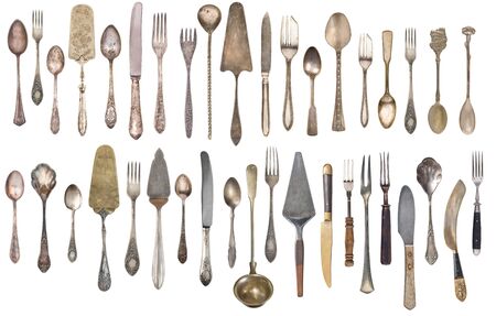 Top view of beautiful vintage silver knifes, spoons and forks  isolated on white background. Silverware. の写真素材