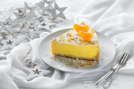 Classic New York cheesecake with tangerines on a white christmas concrete background. Copy space.の写真素材