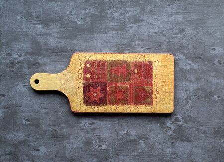 Wooden cutting board on gray concrete background. Table top view and copy space for text. Restaurant menu, recipe, food background mock up. Copy space.の写真素材