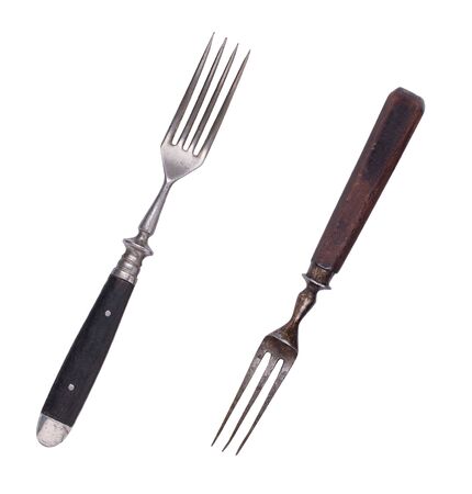 Beautiful old vintage forks isolated on white background. Top view. Retro silverware.の写真素材