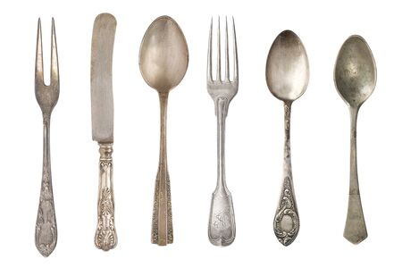 Beautiful old vintage forks. spoons and knife isolated on white background. Top view. Retro silverware.の写真素材