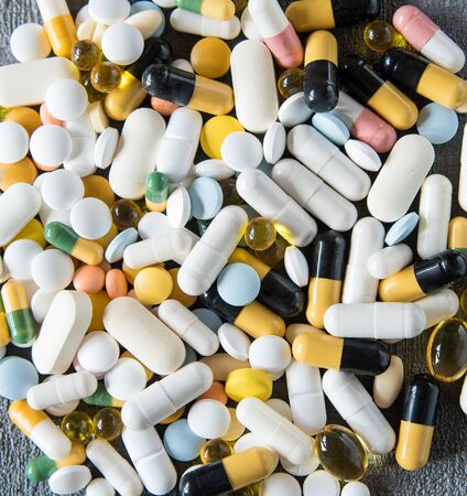 Different colored medications and tablets. Concept of Health Care.の写真素材