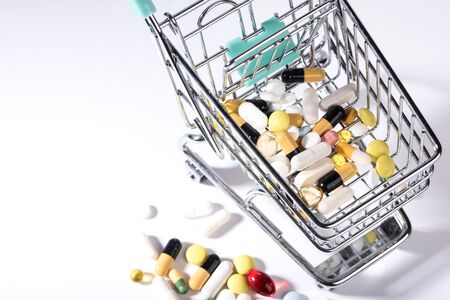 Pills spilled out of shopping cart, top view. Medication and medicine tablets. Copy spaceの写真素材