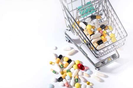 Pills spilled out of shopping cart, top view. Medication and medicine tablets. Copy spaceの写真素材