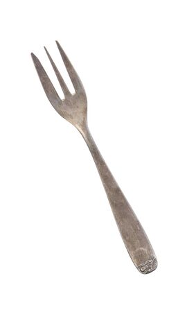 Beautiful old vintage fork isolated on white background. Top view. Retro silverware.の写真素材