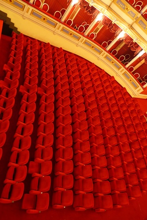Red chairs in the theater in several rowsの写真素材