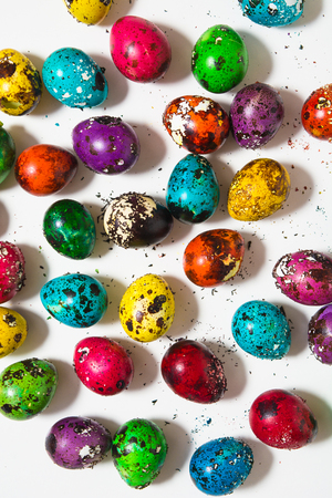 Color shabby quail eggs on the white background, top view, vertical shotの写真素材