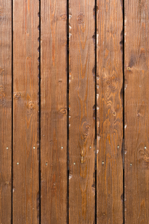 Background of brown wooden vertical panel plank wall backgroundの写真素材