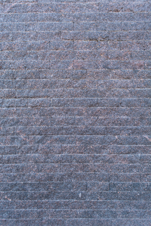 Background of the blue-grey brick wall with horizontal masonry, vertical shotの写真素材