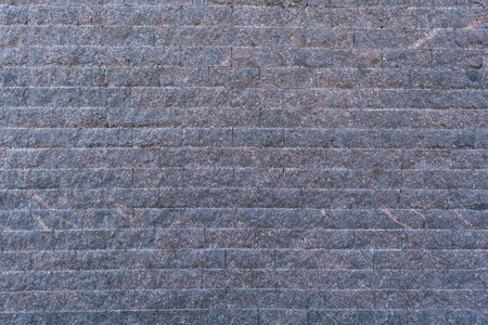 Background of the blue-grey brick wall with horizontal masonryの写真素材