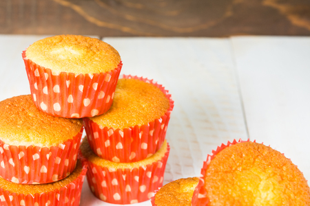 Stack of muffins in red form on white wooden backgroundの写真素材