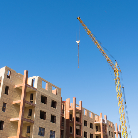 House construction with building crane with blue skyの写真素材