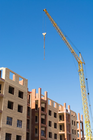 House construction with building crane with blue skyの写真素材