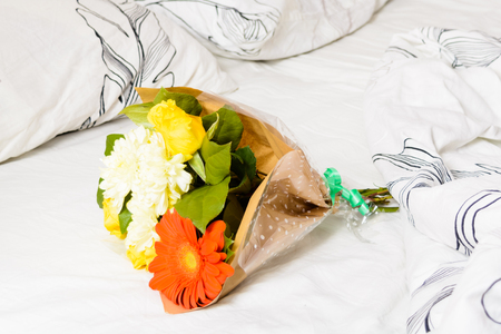 Bouquet of flowers on white bedの写真素材