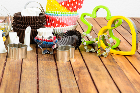 Different baking accessories over brown wooden table and white background with copy spaceの写真素材