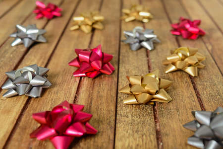 Background of bows for gifts over brown wooden tableの写真素材