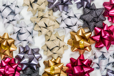 Background of festive bows on white backdrop, top viewの写真素材
