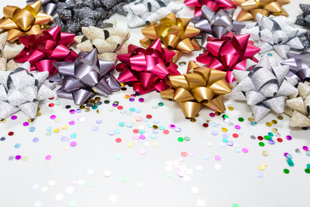 Many christmas bows with confetti on white backgroundの写真素材