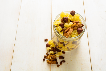 Breakfast with dried fruits and nuts on white wooden table with copy spaceの写真素材